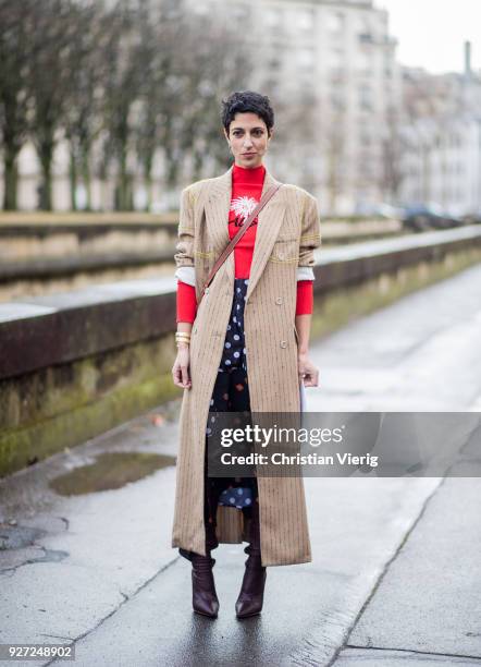 Yasmin Sewell wearing red turtleneck, beige coat is seen outside Valentino during Paris Fashion Week Womenswear Fall/Winter 2018/2019 on March 4,...