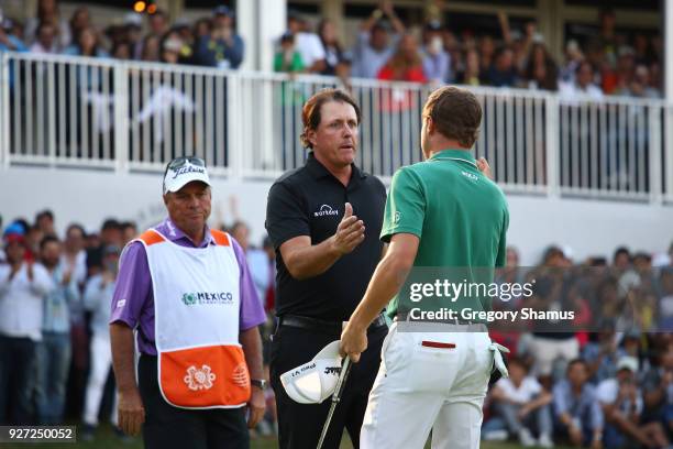 Phil Mickelson shakes hand with Justin Thomas after winning the tournament on an play off hole during the final round of World Golf...