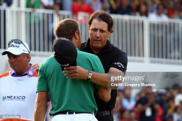 Phil Mickelson shakes hand with Justin Thomas after winning the tournament on an play off hole during the final round of World Golf...