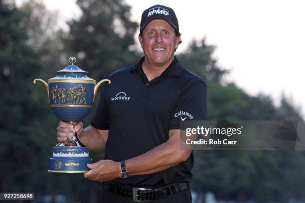 Phil Mickelson poses with the Gene Sarazen Cup after winning the World Golf Championships-Mexico Championship on a playoff hole at Club De Golf...