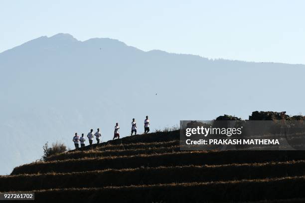 This photograph taken on February 15 shows Nepali Buddhist monks running during a training session in Sindhukot village, some 80 kilometres northeast...