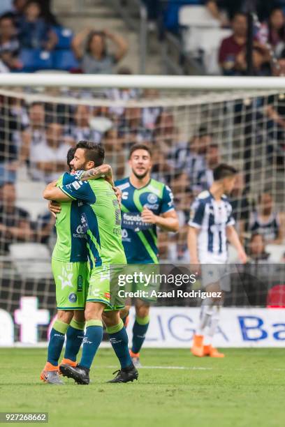 Omar Fernandez of Puebla celebrates with teammates after scoring his team's first goal during the 10th round match between Monterrey and Puebla as...