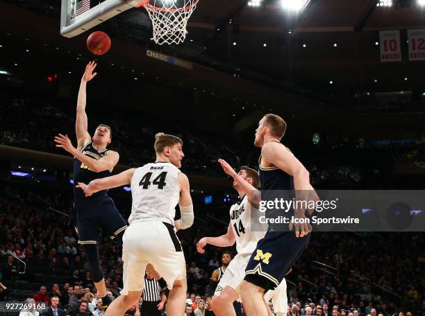 Michigan Wolverines guard Duncan Robinson puts up a hook shot during the Mens College Basketball Big Ten Tournament Championship Game between the...