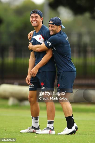 Joseph Manu and Cooper Cronk share a laugh during a Sydney Roosters NRL training session at Kippax Lake on March 5, 2018 in Sydney, Australia.