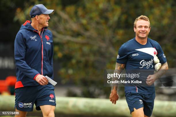 Craig Fitzgibbon and Jake Friend share a joke as they walk to a Sydney Roosters NRL training session at Kippax Lake on March 5, 2018 in Sydney,...