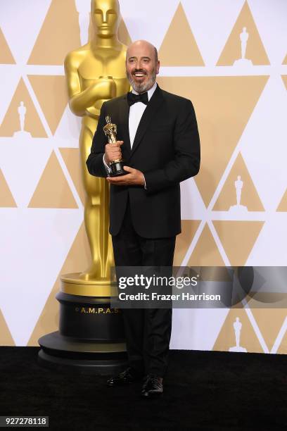 Costume designer Mark Bridges, winner of the Best Costume Design award for 'Phantom Thread,' poses in the press room during the 90th Annual Academy...