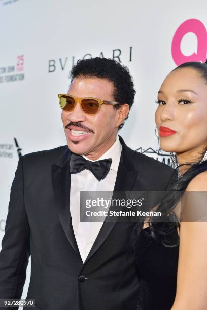 Lionel Richie and Lisa Parigi attend the 26th annual Elton John AIDS Foundation Academy Awards Viewing Party sponsored by Bulgari, celebrating EJAF...