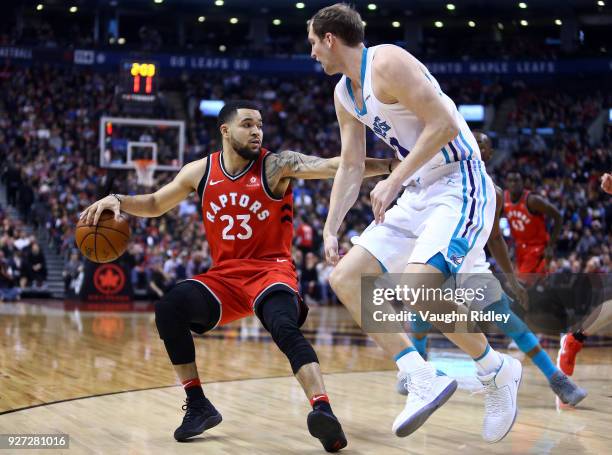 Fred VanVleet of the Toronto Raptors dribbles the ball as Cody Zeller of the Charlotte Hornets defends during the second half of an NBA game at Air...