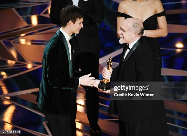 Sound designer Richard King accepts Best Sound Editing for 'Dunkirk' from actor Ansel Elgort onstage during the 90th Annual Academy Awards at the...