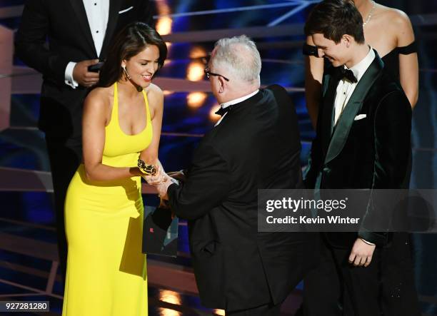 Sound designer Richard King accepts Best Sound Editing for 'Dunkirk' from actors Eiza Gonzalez and Ansel Elgort onstage during the 90th Annual...