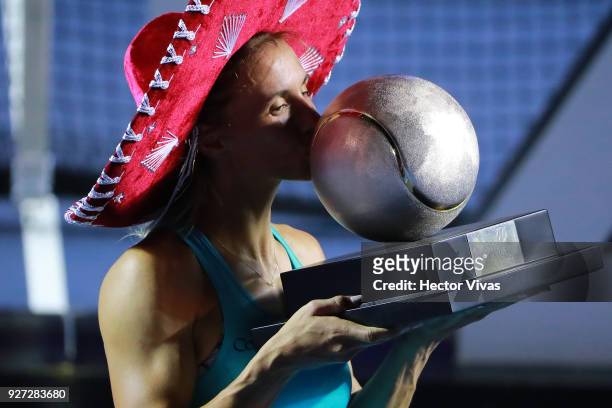 Lesia Tsurenko of Ukraine kisses the champion trophy after winning the Championship match between Stefanie Voegele of Switzerland and Lesia Tsurenko...