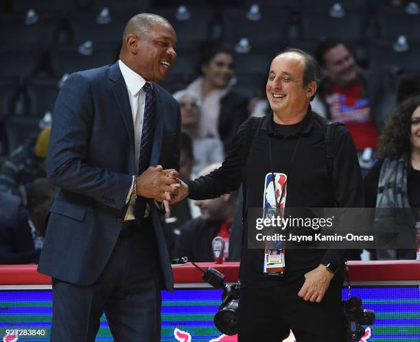 Photographer Andy Bernstein talks with head coach Doc Rivers of the Los Angeles Clippers before the game against the New York Knicks at Staples...