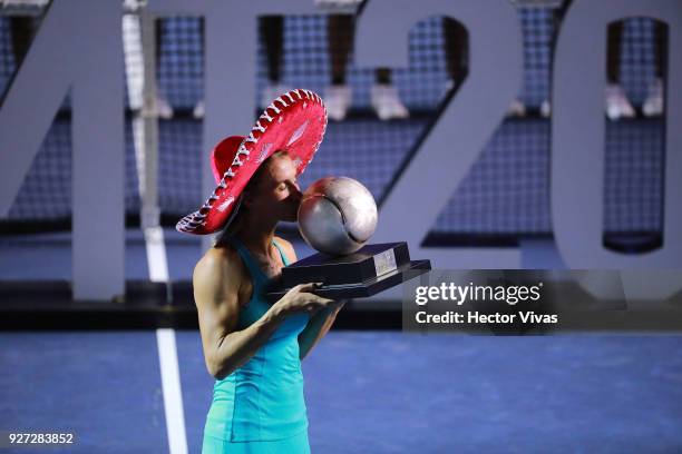 Lesia Tsurenko of Ukraine kisses the champion trophy after winning the Championship match between Stefanie Voegele of Switzerland and Lesia Tsurenko...