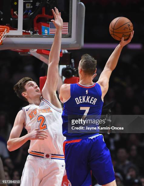 Luke Kornet of the New York Knicks defends a shot by Sam Dekker of the Los Angeles Clippers in the game at Staples Center on March 2, 2018 in Los...