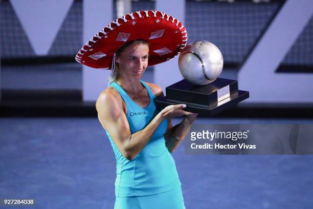 Lesia Tsurenko of Ukraine celebrates with the champion trophy after winning the Championship match between Stefanie Voegele of Switzerland and Lesia...