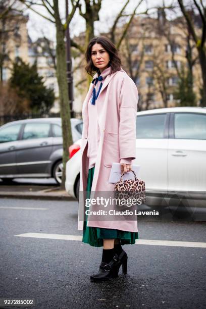 Deborah Reyner Sebag, wearing pink coat and Mehry Mu animalier bag, is seen in the streets of Paris before the Akris show during Paris Fashion Week...