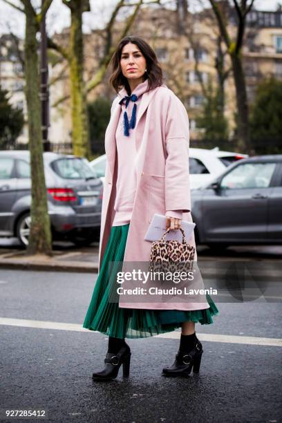 Deborah Reyner Sebag, wearing pink coat and Mehry Mu animalier bag, is seen in the streets of Paris before the Akris show during Paris Fashion Week...