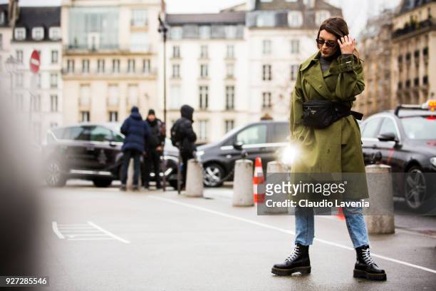 Carlotta Rubaltelli, wearing green trench coat, Prada bag and DrMartens boots, is seen in the streets of Paris before the Givenchy show during Paris...