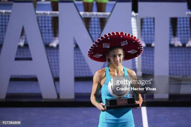 Lesia Tsurenko of Ukraine celebrates with the champion trophy after winning the Championship match between Stefanie Voegele of Switzerland and Lesia...
