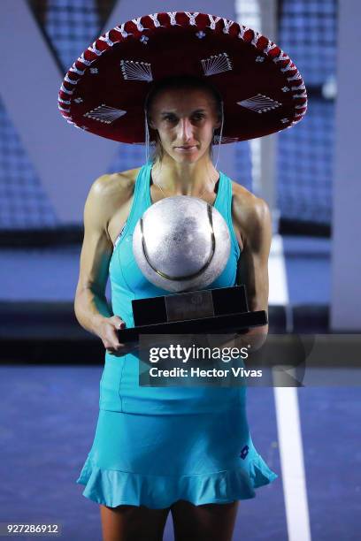 Lesia Tsurenko of Ukraine celebrates with the champion trophy after winning the Championship match between Stefanie Voegele of Switzerland and Lesia...