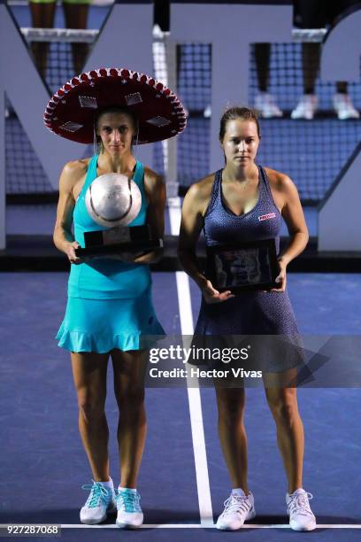 Lesia Tsurenko of Ukraine celebrates with the champion trophy while Stefanie Voegele of Switzerland poses with second place trophy after the...