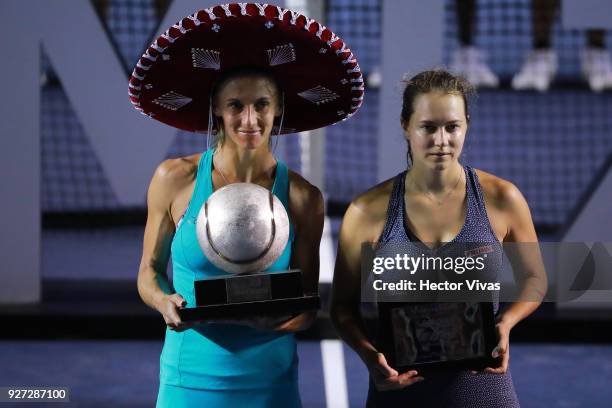 Lesia Tsurenko of Ukraine celebrates with the champion trophy while Stefanie Voegele of Switzerland poses with second place trophy after the...