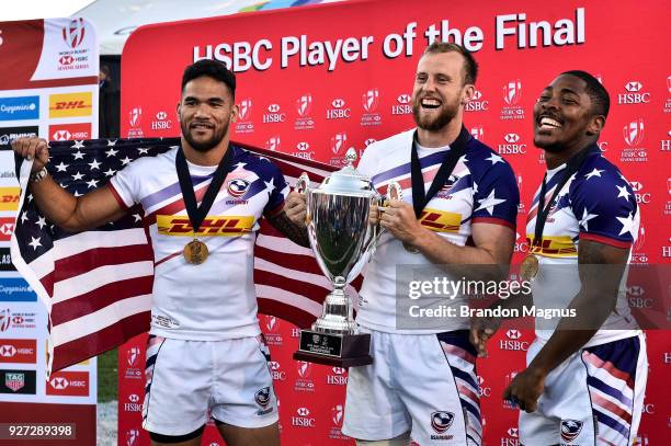 Martin Iosefo Ben Pinkelman and Kevon Williams of the United States celebrate after winning the Cup Final match 28-0 over Argentina during the USA...
