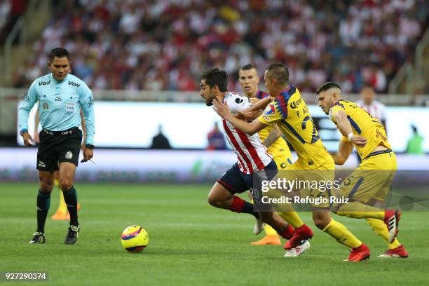 Rodolfo Pizarro of Chivas fights for the ball with Paul Aguilar of America during the 10th round match between Chivas and America as part of the...