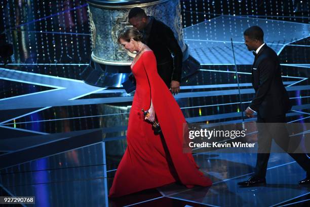 Actor Allison Janney walks offstage with actor Mahershala Ali after accepting Best Supporting Actress for 'I, Tonya' onstage during the 90th Annual...