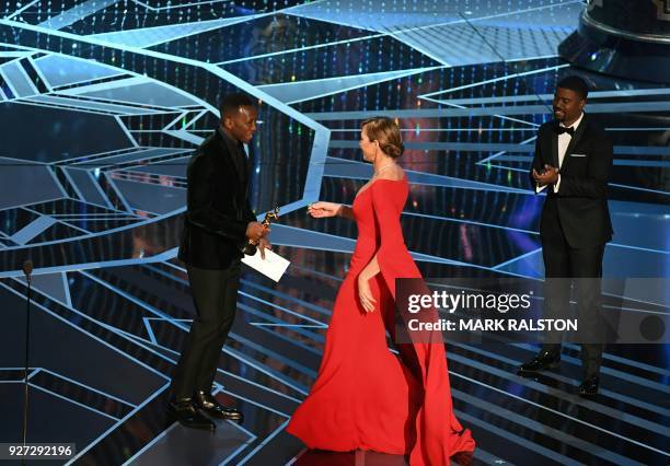 Actress Allison Janney accepts the Oscar for Best Supporting Actress in "I, Tonya" from actor Mahershala Ali during the 90th Annual Academy Awards...