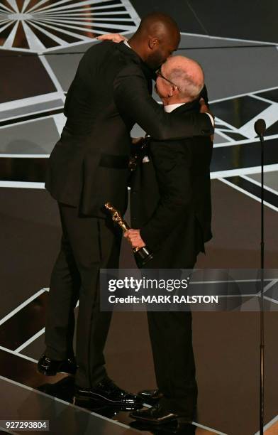 Basketball player Kobe Bryant and US director Glen Keane celebrate after they won the Best Animated Short Film for "Dear Basketball" during the 90th...