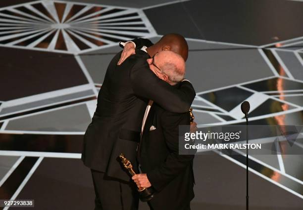Basketball player Kobe Bryant and US director Glen Keane celebrate after they won the Best Animated Short Film for "Dear Basketball" during the 90th...