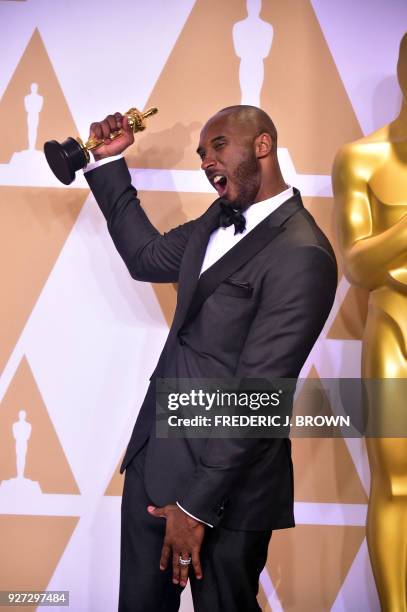 Kobe Bryant poses in the press room with the Oscar for Best Animated Short Film for "Dear Basketball," during the 90th Annual Academy Awards on March...