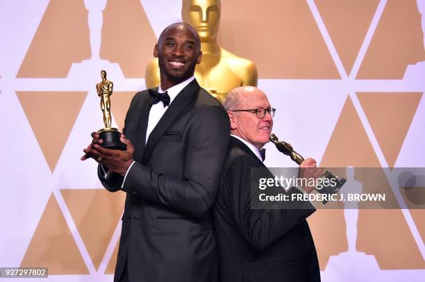 Kobe Bryant and Glen Keane pose in the press room with the Oscar for Best Animated Short Film for "Dear Basketball," during the 90th Annual Academy...