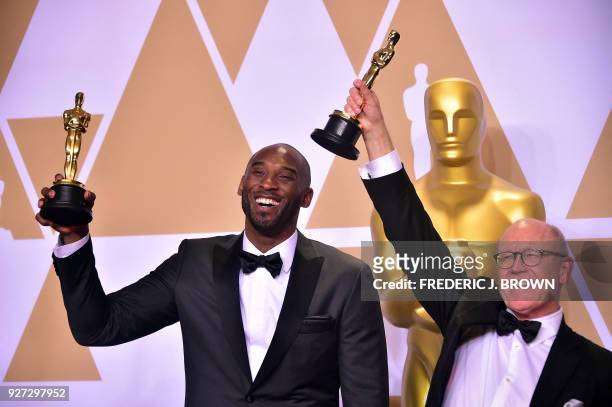 Kobe Bryant and Glen Keane pose in the press room with the Oscar for Best Animated Short Film for "Dear Basketball," during the 90th Annual Academy...