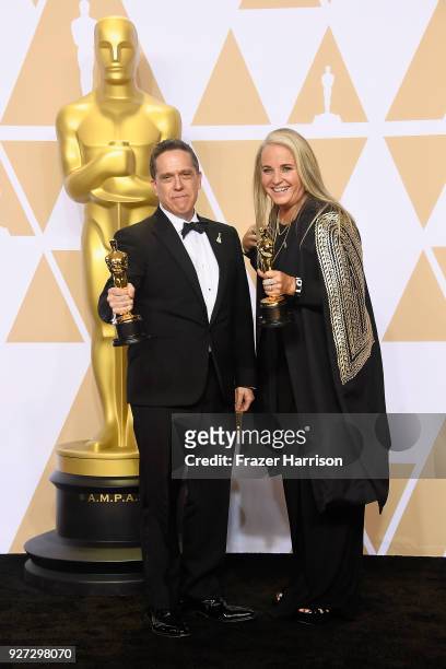 Filmmakers Lee Unkrich and Darla K. Anderson, winners of the Best Animated Feature Film for 'Coco,' pose in the press room during the 90th Annual...