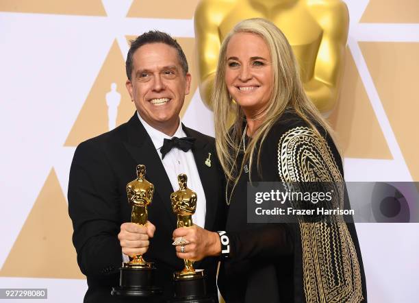 Filmmakers Lee Unkrich and Darla K. Anderson, winners of the Best Animated Feature Film for 'Coco,' pose in the press room during the 90th Annual...