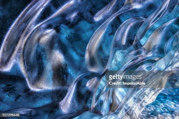 crystal clear shiny ice cave texture in winter iceland - crystal caves ストックフォトと画像