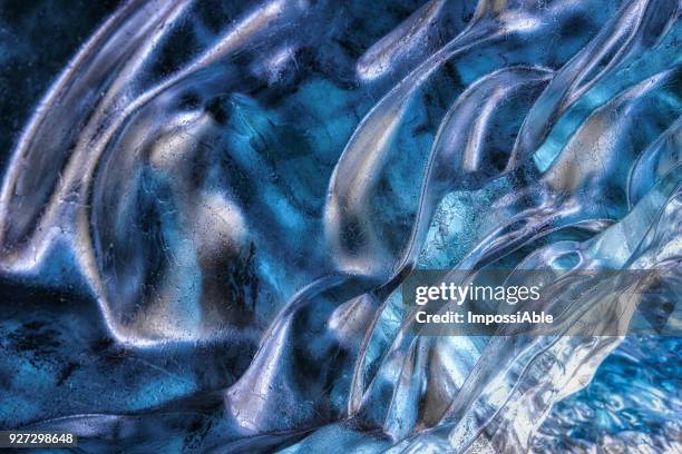 crystal clear shiny ice cave texture in winter iceland - ice cave imagens e fotografias de stock