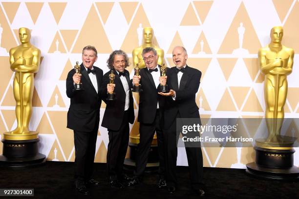 Visual effects artists Richard R. Hoover, Paul Lambert, Gerd Nefzer, and John Nelson, winners of the Best Visual Effects award for 'Blade Runner...