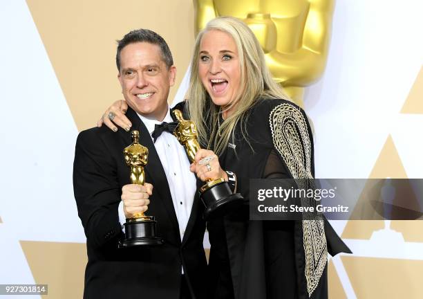 Director Lee Unkrich and Producer Darla K. Anderson, winners of the Animated Feature award for Coco pose in the press room during the 90th Annual...