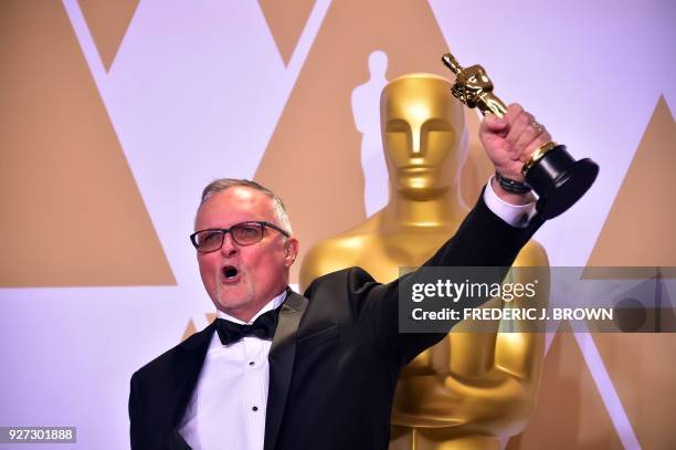 Film Editor Lee Smith poses in the press room with the Oscar for Best Film Editing for "Dunkirk," during the 90th Annual Academy Awards on March 4 in...