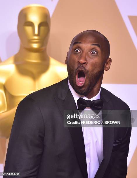 Kobe Bryant poses in the press room with the Oscar for Best Animated Short Film for "Dear Basketball," during the 90th Annual Academy Awards on March...
