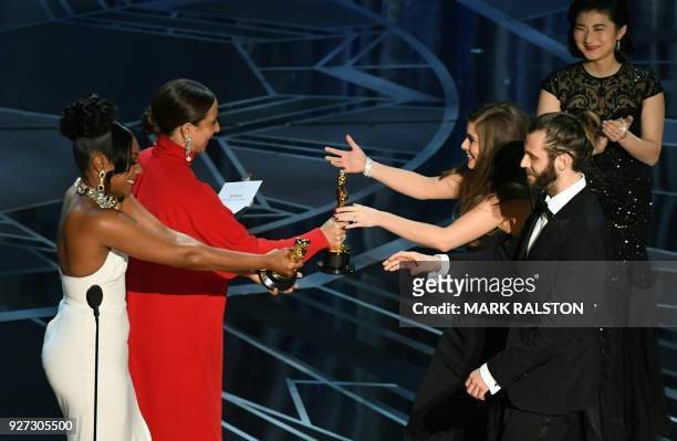 British actor and director Chris Overton and British actress Rachel Shenton are congratulated by US actress Maya Rudolph and comedian Tiffany Haddish...