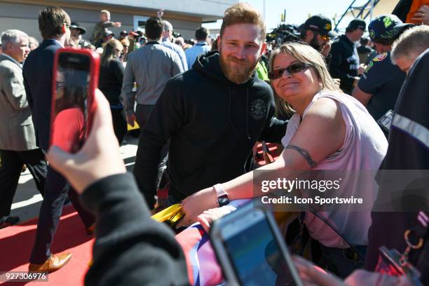 Monster Energy NASCAR Cup Series driver Jeffrey Earnhardt poses for a photo with a fan during the Monster Energy NASCAR Cup Series Pennzoil 400...