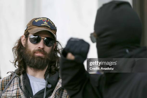 Supporter of Donald Trump looks at counter protestor during pro-Trump rally in Oregon's state capital, Salem, on March 4, 2018.