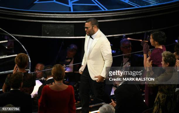 Director Jordan Peele reacts after he won the Oscar for Best Original Screenplay for "Get Out" during the 90th Annual Academy Awards show on March 4,...
