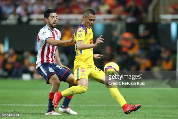 Rodolfo Pizarro of Chivas fights for the ball with Paul Aguilar of America during the 10th round match between Chivas and America as part of the...