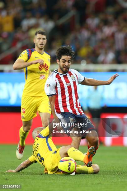 Rodolfo Pizarro of Chivas fights for the ball with Andres Uribe of America during the 10th round match between Chivas and America as part of the...