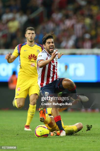 Rodolfo Pizarro of Chivas fights for the ball with Andres Uribe of America during the 10th round match between Chivas and America as part of the...